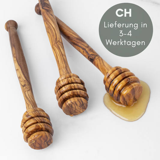 alt="Honiglöffel aus Olivenholz mit natürlicher Maserung, ideal zum Dosieren von Honig"
